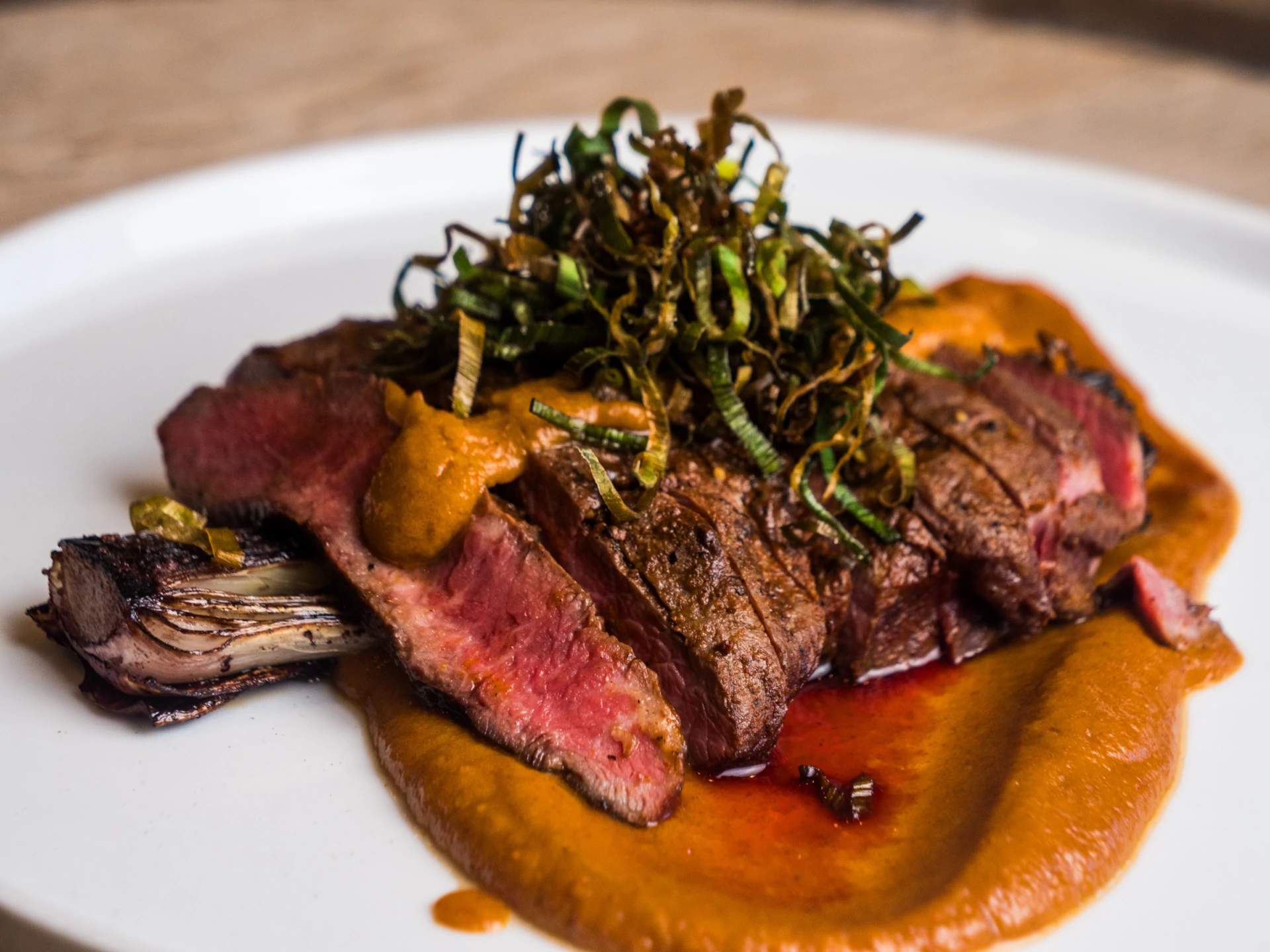 Grilled Flat Iron with Braised Leeks and Harissa Date Puree